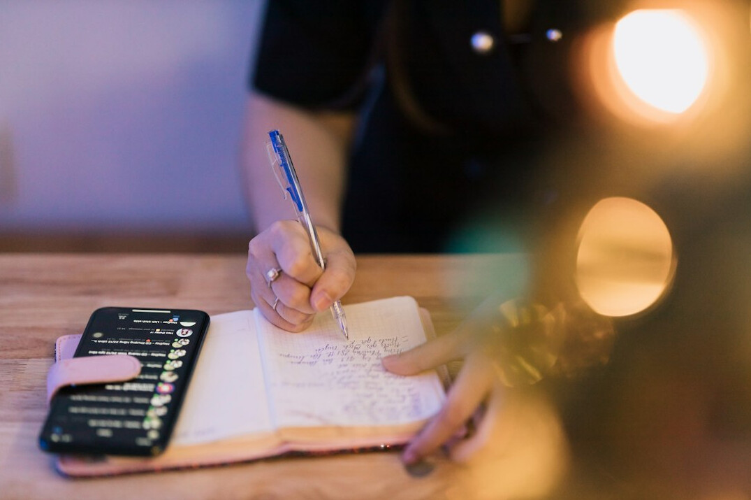 woman writing budget plan